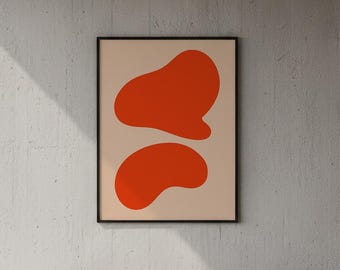 May include: A framed abstract art print featuring two orange organic shapes on a beige background. The artwork hangs above a bed with white bedding. A small lamp sits on a wooden nightstand.