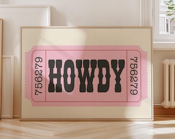 May include: A framed print featuring a pink ticket design with the word "HOWDY" in bold black letters. The ticket has the numbers 756279 on each side. The background is a light beige color.