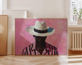 May include: A framed painting of a person wearing a white hat with a black band and a pink and black striped shirt. The background is a solid pink color. The artwork is displayed in a room with a wooden floor.