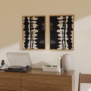 Set of 2 black and white abstract ink drawings inspired by zebra patterns. These modern monochrome paintings feature fluid brushstrokes, creating a minimalist and sophisticated gallery wall. Perfect for Japandi, Scandi, or contemporary home decor, this artistic duo brings elegance and contrast to any living room, bedroom, or office.