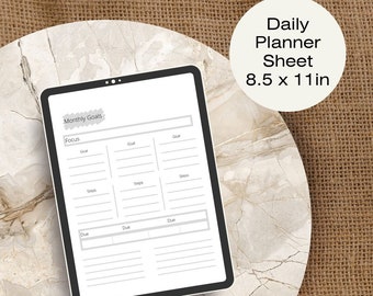May include: A printable daily planner sheet with a monthly goals section. The sheet is designed for use with a tablet or laptop and measures 8.5 x 11 inches.