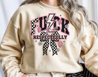May include: Beige sweatshirt with a graphic design. The design features the words "FUCK THAT RESPECTFULLY" in black and pink, with a lightning bolt, smiley faces, and checkered bow accents. The sweatshirt has a crew neck and long sleeves.