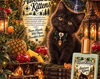 May include: A rectangular 15 ml glass perfume bottle labeled Velour Kittens Adventurine Kittens featuring a black kitten with a green plaid bow. The label displays a pineapple, red apples, and a forest scene. The bottle has a gold cap.
