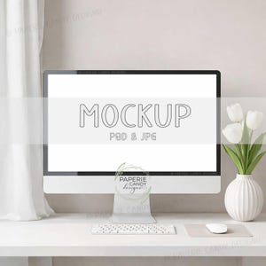 May include: A modern computer monitor with the word "MOCKUP" and "PSD & JPG" displayed on the screen. A white keyboard, mouse, and mousepad are in front of the monitor. A white vase with white tulips sits to the right.