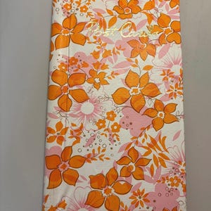 Álbum de postales vintage con motivos florales en tonos rosa y naranja