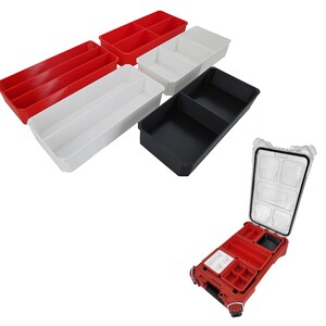 May include: Four empty plastic storage containers with dividers. The containers are red, white, and black. A red container with dividers is open and sitting on a white surface.