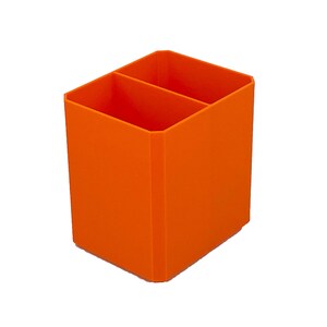 May include: Bright orange desk organizer with two compartments. The rectangular container is made of a solid material and is designed to hold pens, pencils, or other office supplies. The organizer is set against a white background.
