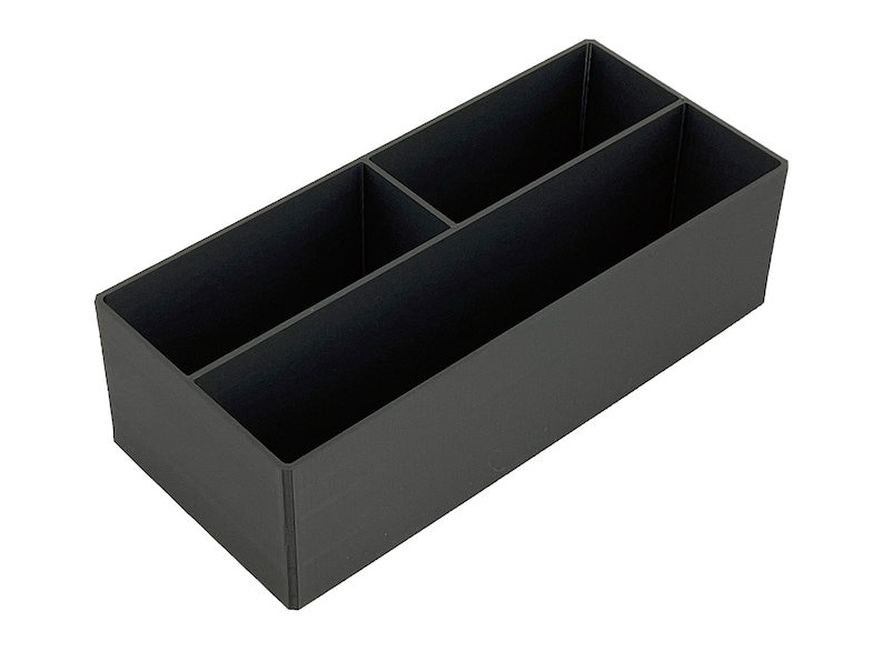 May include: A black plastic desk organiser with three compartments.