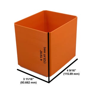 May include: An orange plastic storage cube with measurements in inches and millimeters. The cube is 4 15/16 inches tall, 3 11/16 inches wide, and 4 9/16 inches deep.