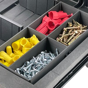 May include: A black plastic storage box with four compartments. The compartments are filled with various hardware items, including red and yellow wire connectors, silver screws, and gold screws.