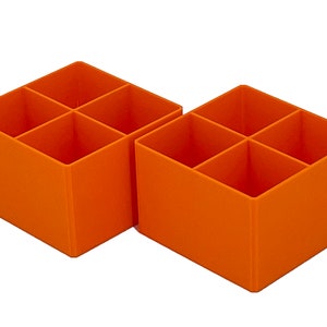 May include: Two orange plastic storage boxes with four compartments each. The boxes are empty.
