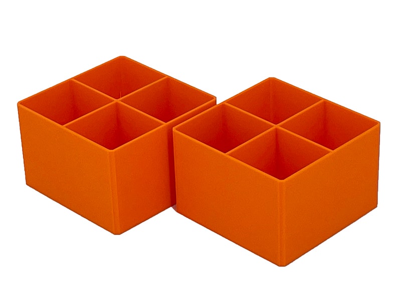 May include: Two orange plastic storage boxes with four compartments each. The boxes are empty.