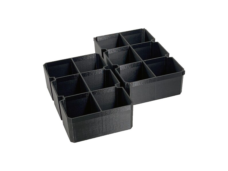 May include: Black plastic organizer with multiple compartments. The organizer is divided into several rectangular sections, ideal for storing small items. The design is simple and functional, suitable for various organizational needs.