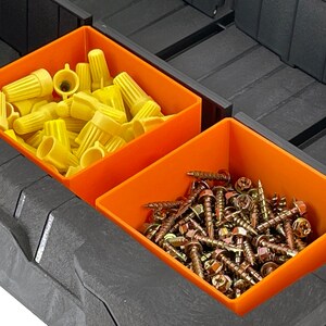 May include: Two orange plastic storage bins with dividers. One bin contains yellow wire connectors and the other bin contains gold screws.