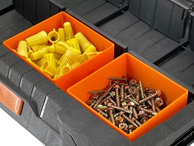 May include: Two orange plastic storage bins with dividers. One bin contains yellow wire connectors and the other bin contains gold screws.