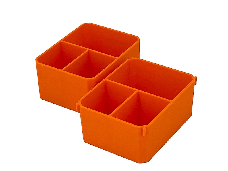 May include: Two bright orange plastic storage organisers. Each organiser is divided into three compartments. The containers are designed to hold small items and keep them organised. The containers are made of a durable plastic material.