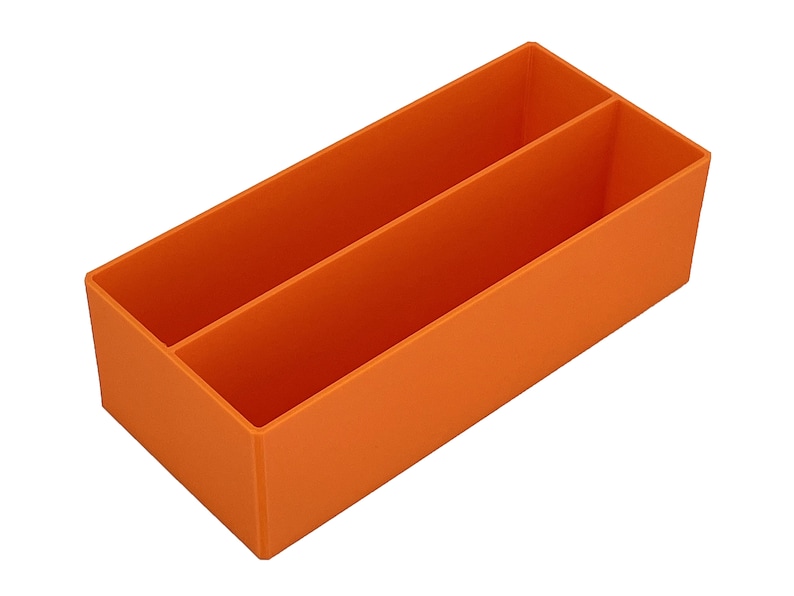 May include: An orange rectangular organiser with two compartments. The organiser is made of a solid material and is designed to hold items. The compartments are separated by a vertical divider.