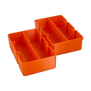 May include: Two bright orange, rectangular storage containers with internal dividers. The containers are made of a solid material and are designed to organize small items. The containers are shown against a white background.