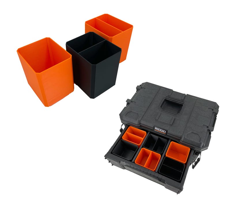 May include: A black and orange tool organizer with multiple compartments. The organizer includes several orange and black storage bins. The open drawer reveals additional orange and black compartments. The brand name "RIDGID" is visible on the case.