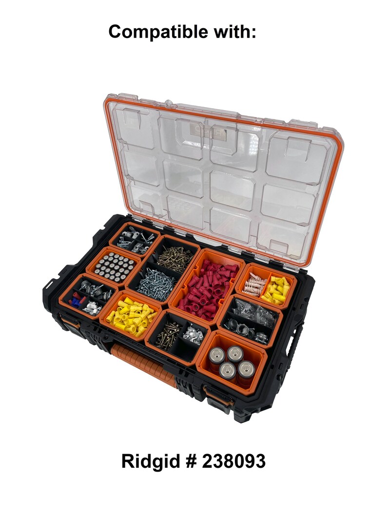 May include: A black and orange Ridgid parts organizer with a clear lid. The organizer is open, revealing various compartments filled with hardware, including screws, connectors, and other small parts. The text "Compatible with:" and "Ridgid # 238093" are visible.