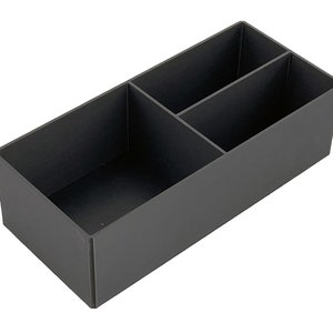 May include: A black plastic storage box with three compartments. The box is empty and has a rectangular shape.