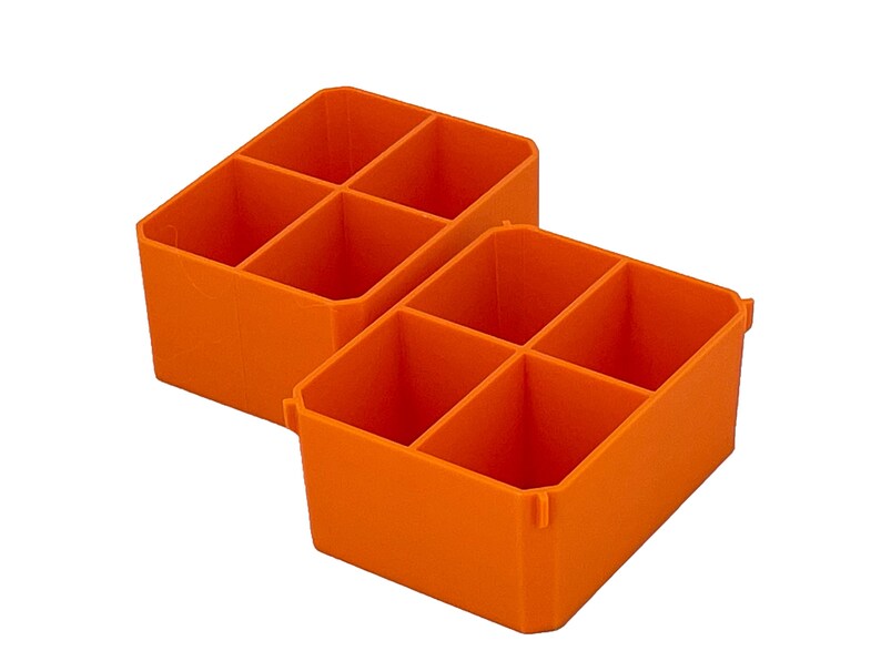 May include: Two bright orange storage bins, each divided into six compartments. The bins are angled and made of a solid, opaque material. Suitable for organising small items in a workshop or craft room.