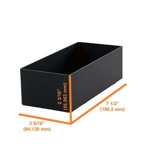 May include: Black rectangular storage box with measurements in inches and millimetres. The box is 3 5/16 inches (84.138 mm) wide, 2 3/16 inches (55.563 mm) tall, and 7 1/2 inches (190.5 mm) long.