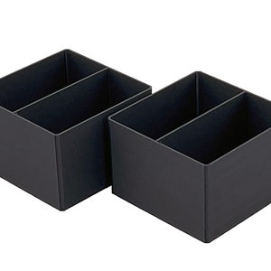 May include: Two black plastic desk organizers with two compartments each.