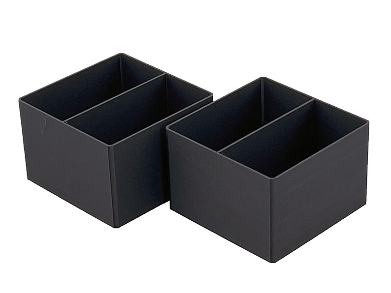 May include: Two black plastic desk organizers with two compartments each.
