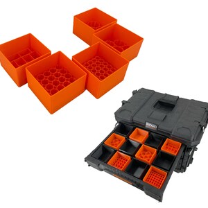 May include: A black toolbox with a drawer that is open. The drawer is filled with orange plastic organizers. The toolbox has the word "RIDGID" printed on the side.