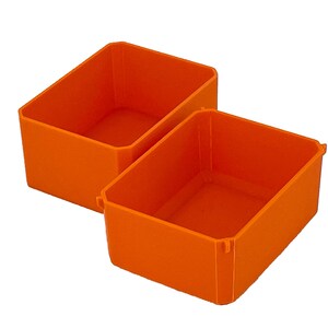 May include: Two bright orange rectangular storage bins are displayed against a white background. The bins are made of a solid material and have a simple, clean design. The bins are empty and ready for use.