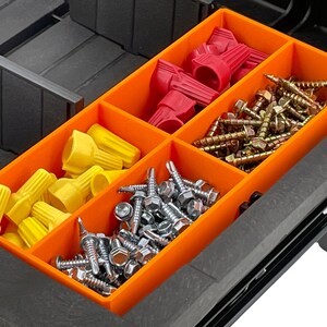 May include: An orange organiser tray with several compartments containing hardware. The tray holds yellow and red wire connectors, alongside various screws, including hex head and wood screws. The tray is inside a black toolbox.