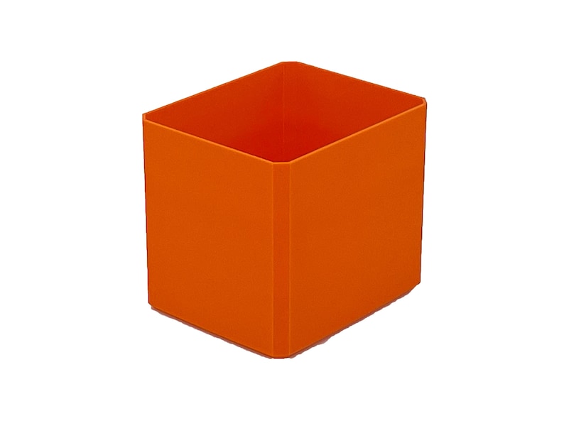 May include: An orange, rectangular storage container with a square opening. The container is made of a solid material and has a smooth surface. The interior of the container is also orange.