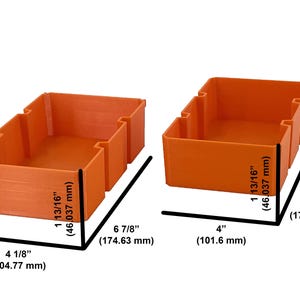 May include: Two orange storage bins. The bin on the left is 4 1/8" (104.77 mm) wide, 6 7/8" (174.63 mm) long, and 1 13/16" (46.037 mm) high. The bin on the right is 4" (101.6 mm) wide, 6 3/4" (171.45 mm) long, and 1 13/16" (46.037 mm) high.