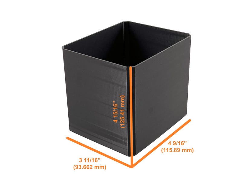 May include: A black, rectangular container with dimensions of 4 15/16 inches (125.41 mm) high, 4 9/16 inches (115.89 mm) wide, and 3 11/16 inches (93.662 mm) deep. The container is empty and has a matte finish.