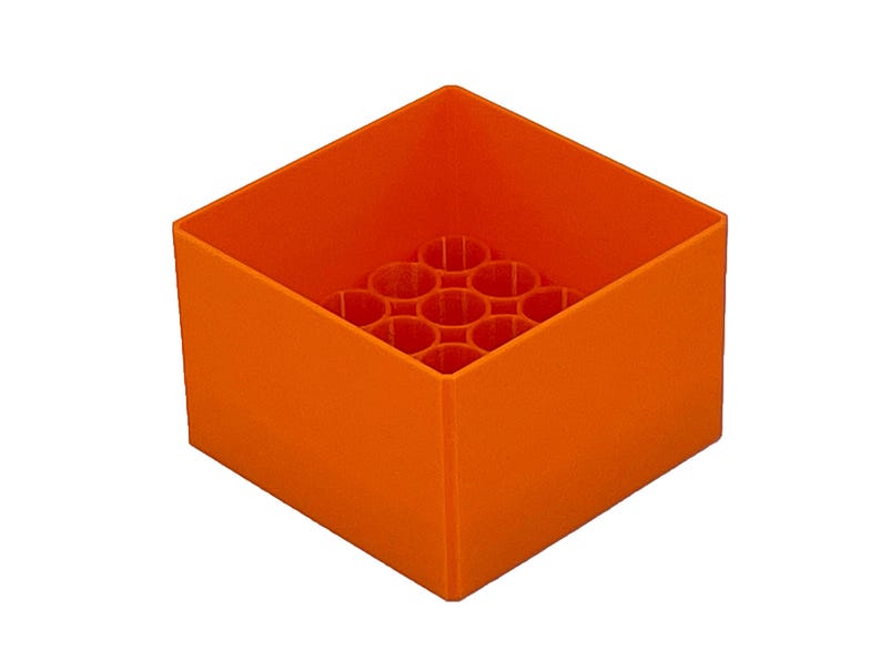 May include: Orange plastic storage box with a grid of circular holes in the bottom. The box is empty.