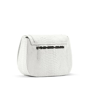 May include: White leather handbag with a snakeskin pattern and a zip closure.