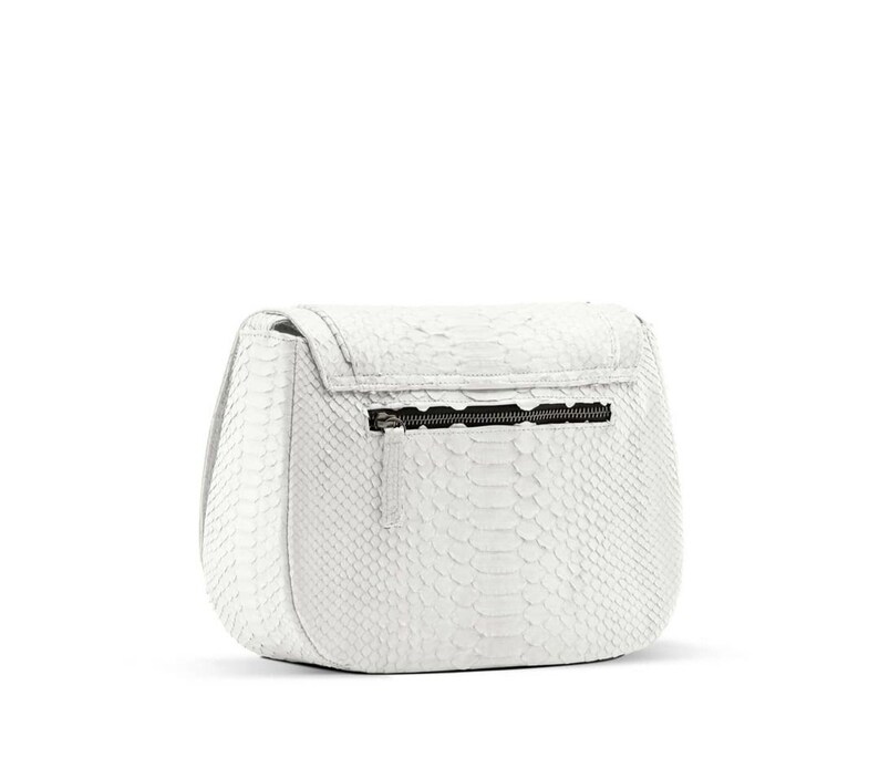 May include: White leather handbag with a snakeskin pattern and a zip closure.