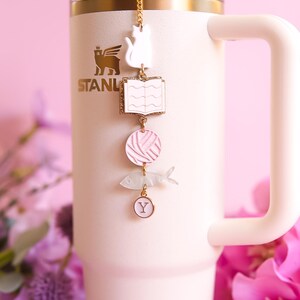 May include: A trio of ceramic mugs with a speckled, matte finish in cream, light grey, and dark grey. Each mug features a simple, minimalist design, ideal for tea or coffee.