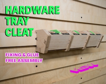 May include: A wooden hardware tray cleat with the text "FIXING & GLUE FREE ASSEMBLY" on the front. The cleat is mounted on a light wood wall and has four trays attached to it.