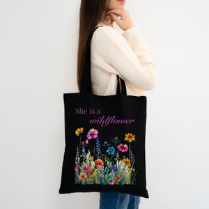 She is a wildflower, The Daisy Exchange, Gifts for her, bestie gifts, birthday gifts, best selling items, bridesmaid tote, embroidered tote, floral backpack, weekend bag, christian tote, farmers market bag, floral botanical canvas bag, everyday tote