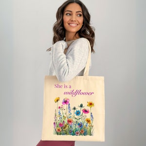 She is a wildflower, The Daisy Exchange, Gifts for her, bestie gifts, birthday gifts, best selling items, bridesmaid tote, embroidered tote, floral backpack, weekend bag, christian tote, farmers market bag, floral botanical canvas bag, everyday tote