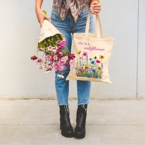 She is a wildflower, The Daisy Exchange, Gifts for her, bestie gifts, birthday gifts, best selling items, bridesmaid tote, embroidered tote, floral backpack, weekend bag, christian tote, farmers market bag, floral botanical canvas bag, everyday tote