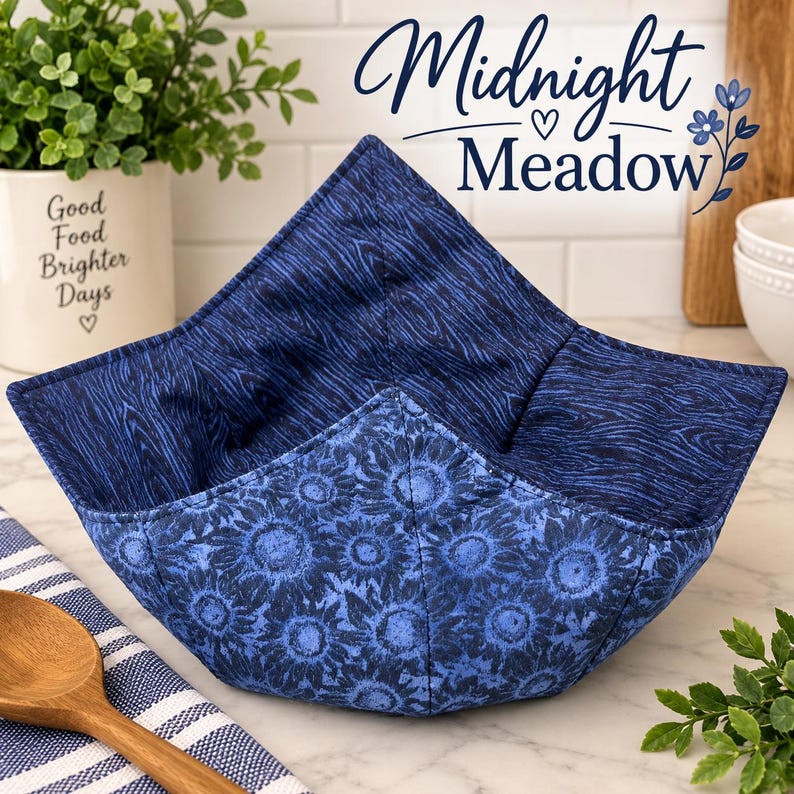 May include: A fabric bowl cozy featuring a dark blue wood grain pattern on the interior and a blue sunflower print on the exterior. The square-shaped quilted holder has four pointed corners and is constructed with visible stitching throughout.
