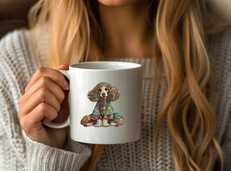 May include: White ceramic mug with a colorful illustration of a dog wearing a floral patterned outfit. The dog has brown fur and is sitting with its legs crossed.