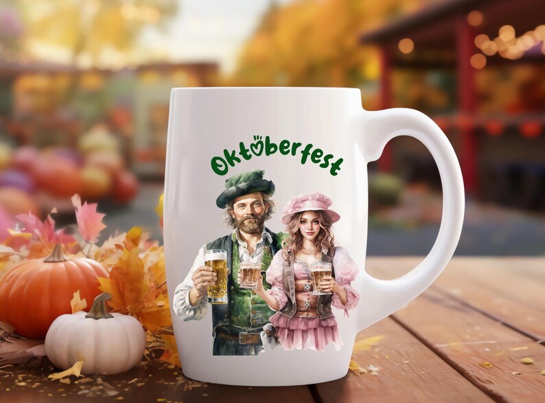 May include: White ceramic mug with a handle, featuring a festive Oktoberfest design. The mug depicts a man and woman in traditional German attire, holding beer steins. The text "Oktoberfest" is written in green lettering.