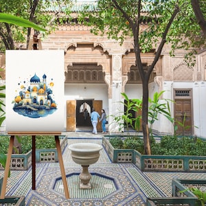 May include: A watercolor painting on canvas depicting a blue and gold castle with a crescent moon and stars. The painting is displayed on an easel in a courtyard with a fountain and tiled floor.