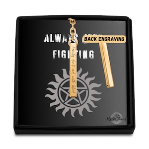 May include: Gold keychain with a rectangular charm that says "Family don't end with blood." The back of the charm is blank for engraving. The keychain is in a black box with the words "Always Keep Fighting" and "Back Engraving" on it.