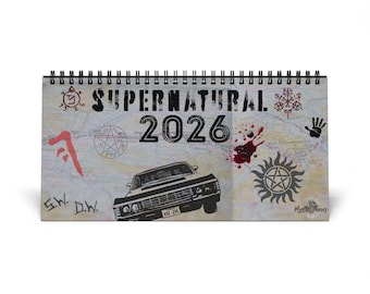 May include: A Supernatural 2026 calendar featuring a black car illustration, the show's logo, and various symbols. The calendar has a spiral binding and a map-themed background. The text "Supernatural 2026" is clearly visible.