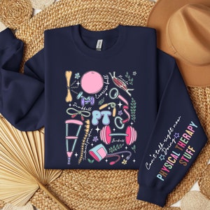 May include: Navy blue sweatshirt with a colorful illustration of physical therapy equipment and the text "Can't talk right now Doing Physical Therapy Stuff".